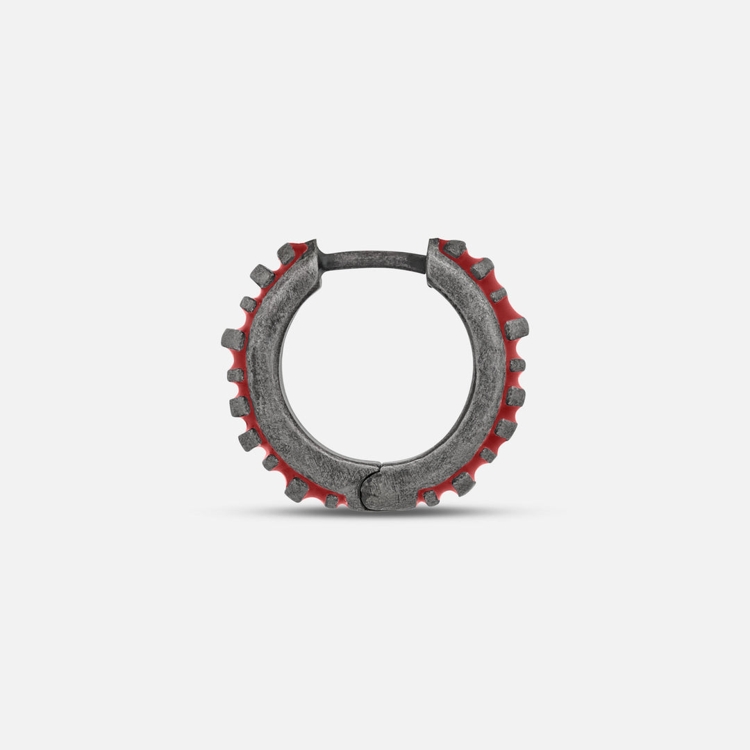 MARCO DAL MASO Acies Mini Hoop Earring in oxidized silver with red enamel, shown in a side-profile product view highlighting the textured hoop and ribbed detailing.