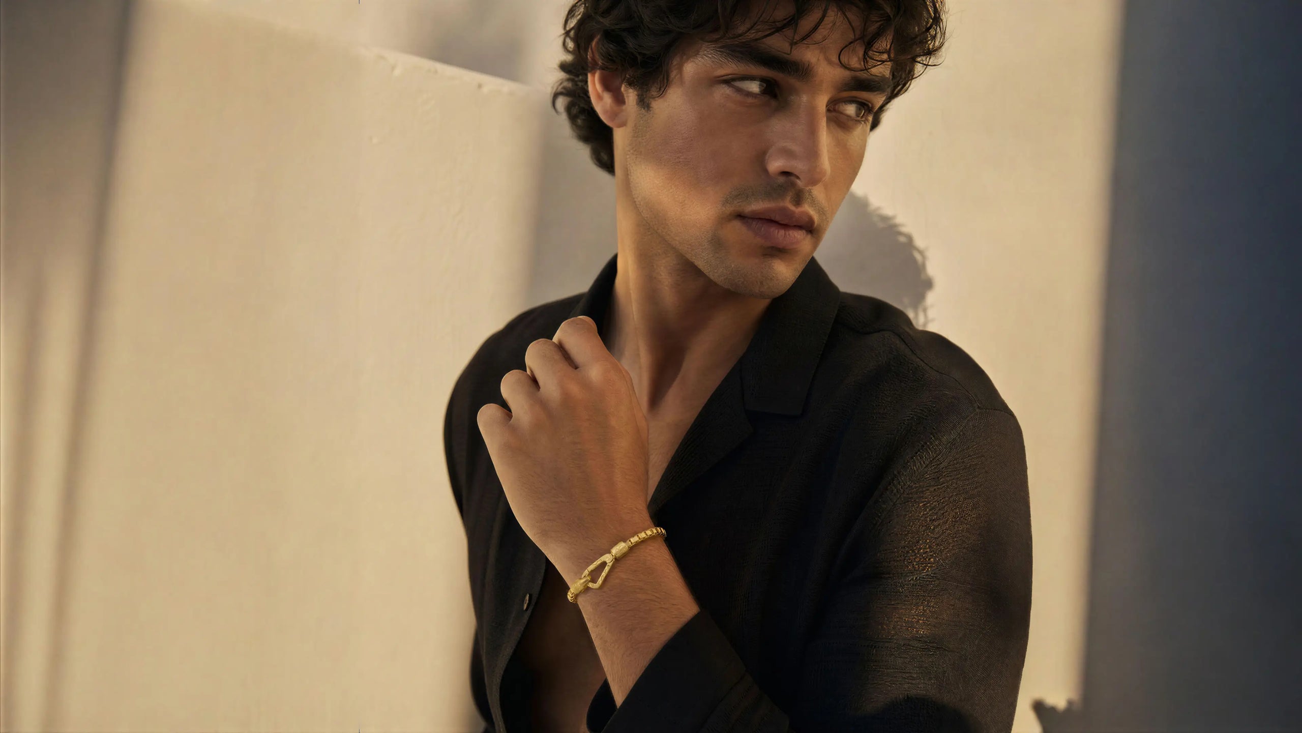 Young man wearing a gold bracelet from Marco Dal Maso