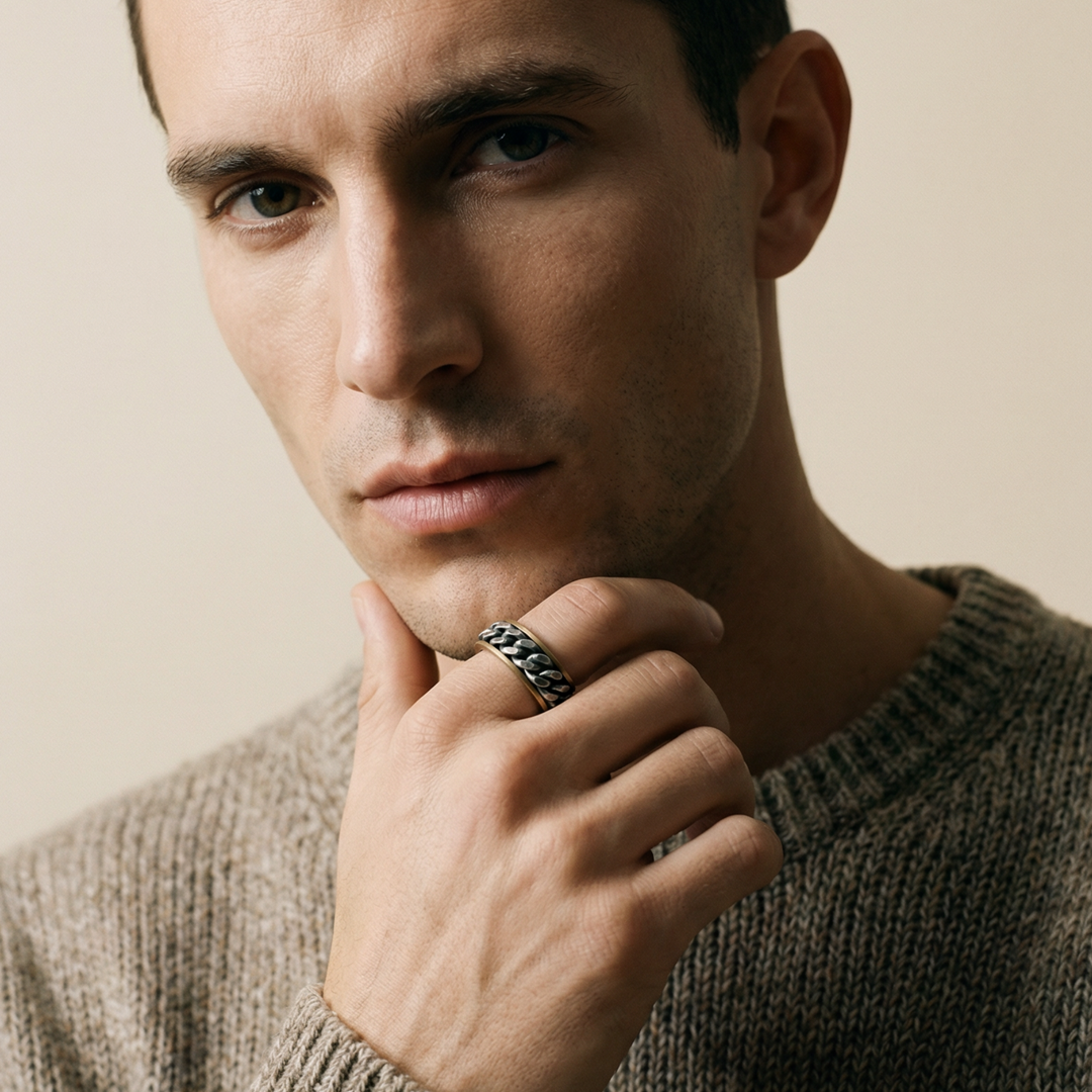 Man wearing a brown sweater with a neutral background