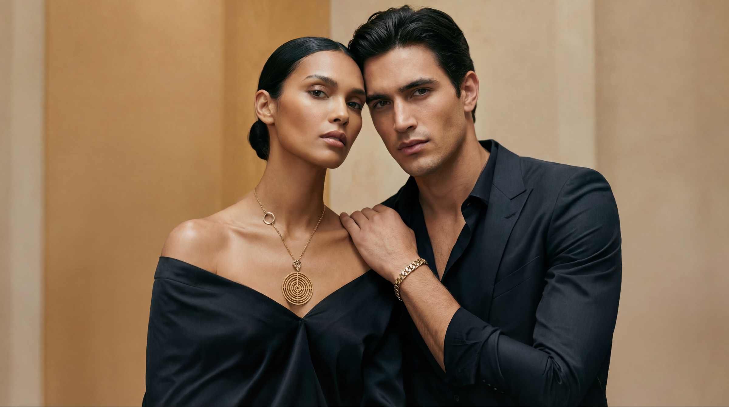 Man and woman posing closely against a beige wall