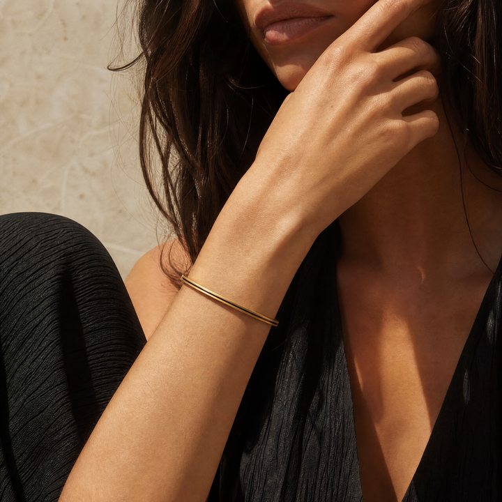 Model wearing the Continuum cuff in 18K yellow gold with black enamel.
