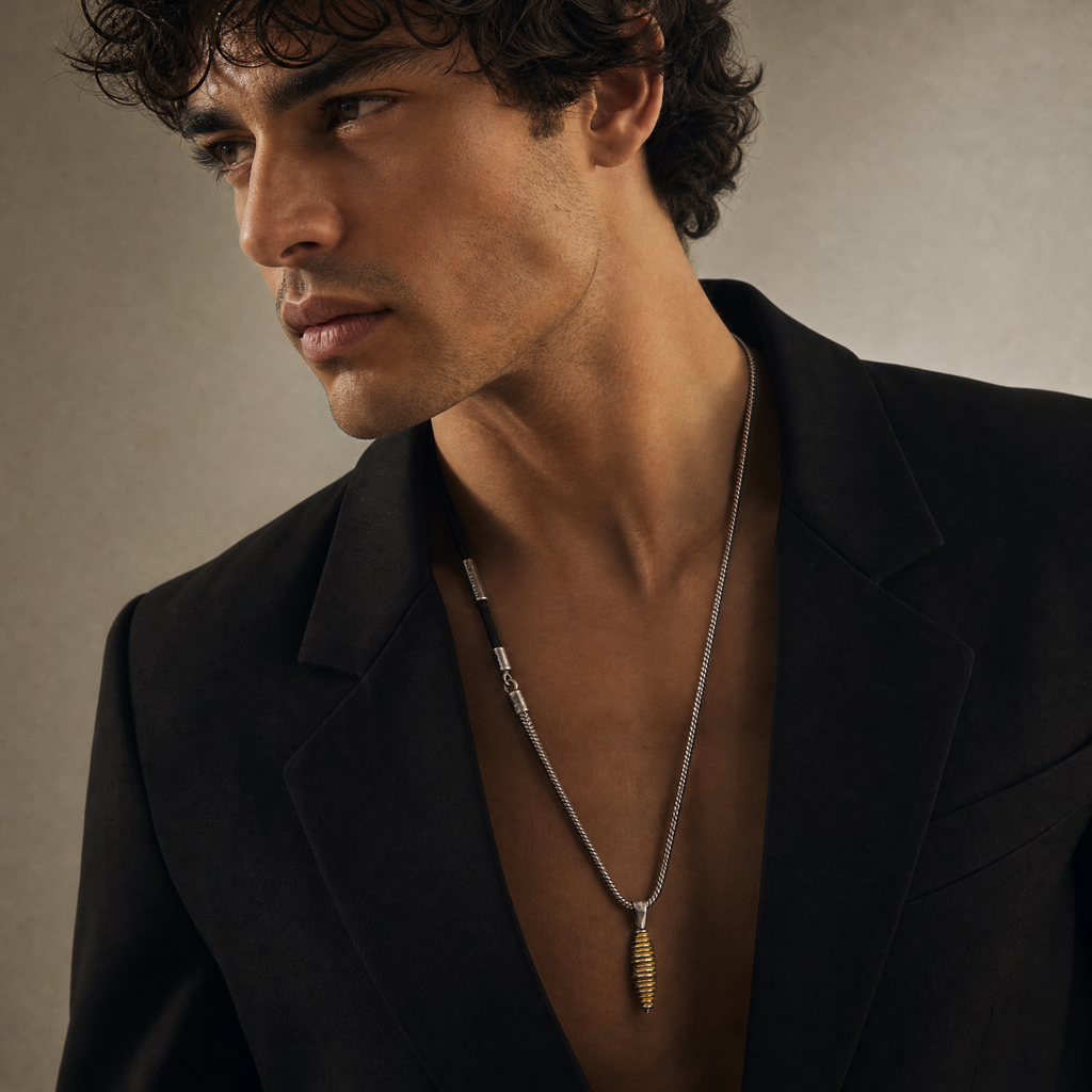 Model wearing the Acies Cocoon Pendant in oxidized silver with yellow enamel and black leather.