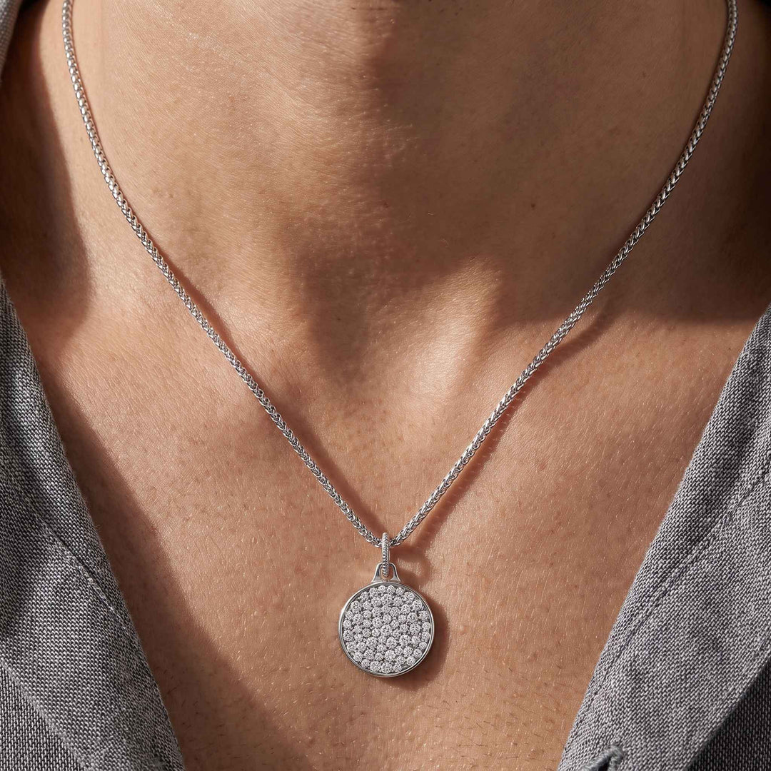 Male model wearing the Moneta Gemstone Pendant in polished silver with white diamonds.