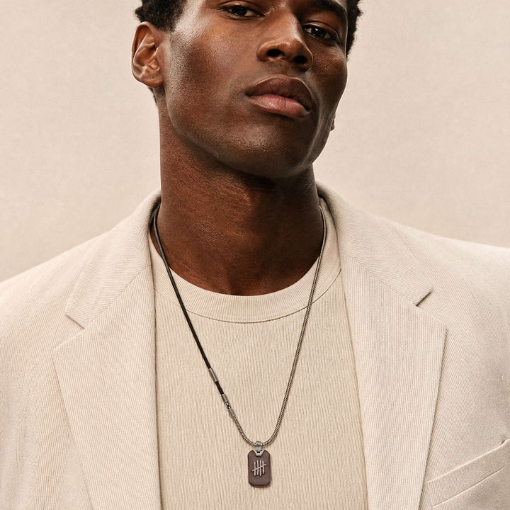 Triumph Pendant with Leather in oxidized silver, brown enamel and brown leather worn by a model.