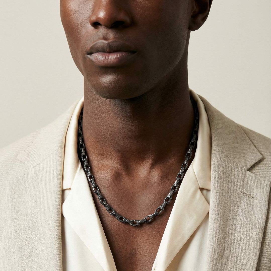 Ulysses Pulled Chain Necklace in oxidized silver worn by a model in a close-up neck shot.