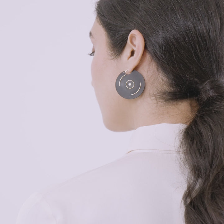 Eclipse Saturn Earrings shown in motion to highlight detail and finish