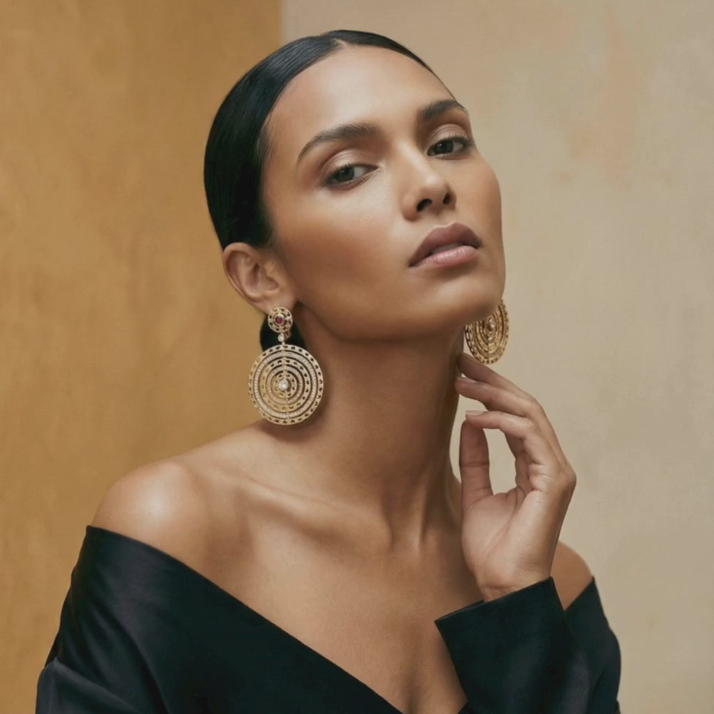 Model wearing Amaia Twilight Earrings, highlighting red sapphire accents and sculptural curve.