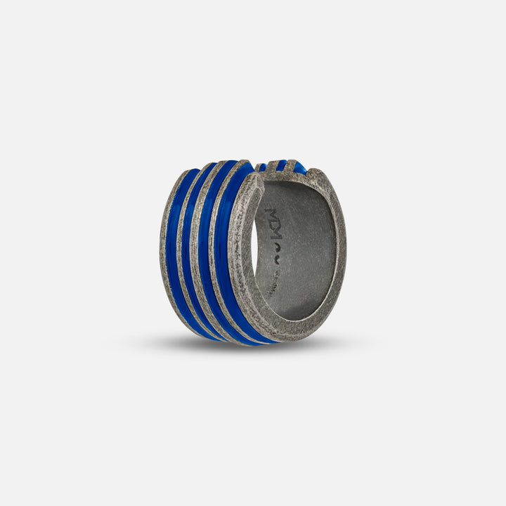 Perspective frame of grooved band displaying cobalt glaze on soft backdrop.