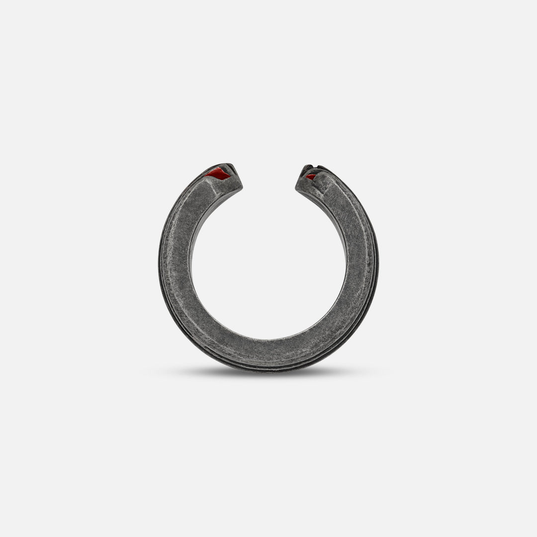 Top-down view of split band exposing crimson hints on a soft platform.