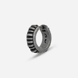 MARCO DAL MASO Acies Mini Hoop Earring in oxidized silver with black enamel detailing, featuring a ribbed hoop design, shown in an angled product view against a light background.