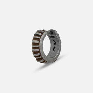 MARCO DAL MASO Acies Mini Hoop Earring in oxidized silver with brown enamel detailing, featuring a ribbed hoop design, shown in an angled product view against a light background.
