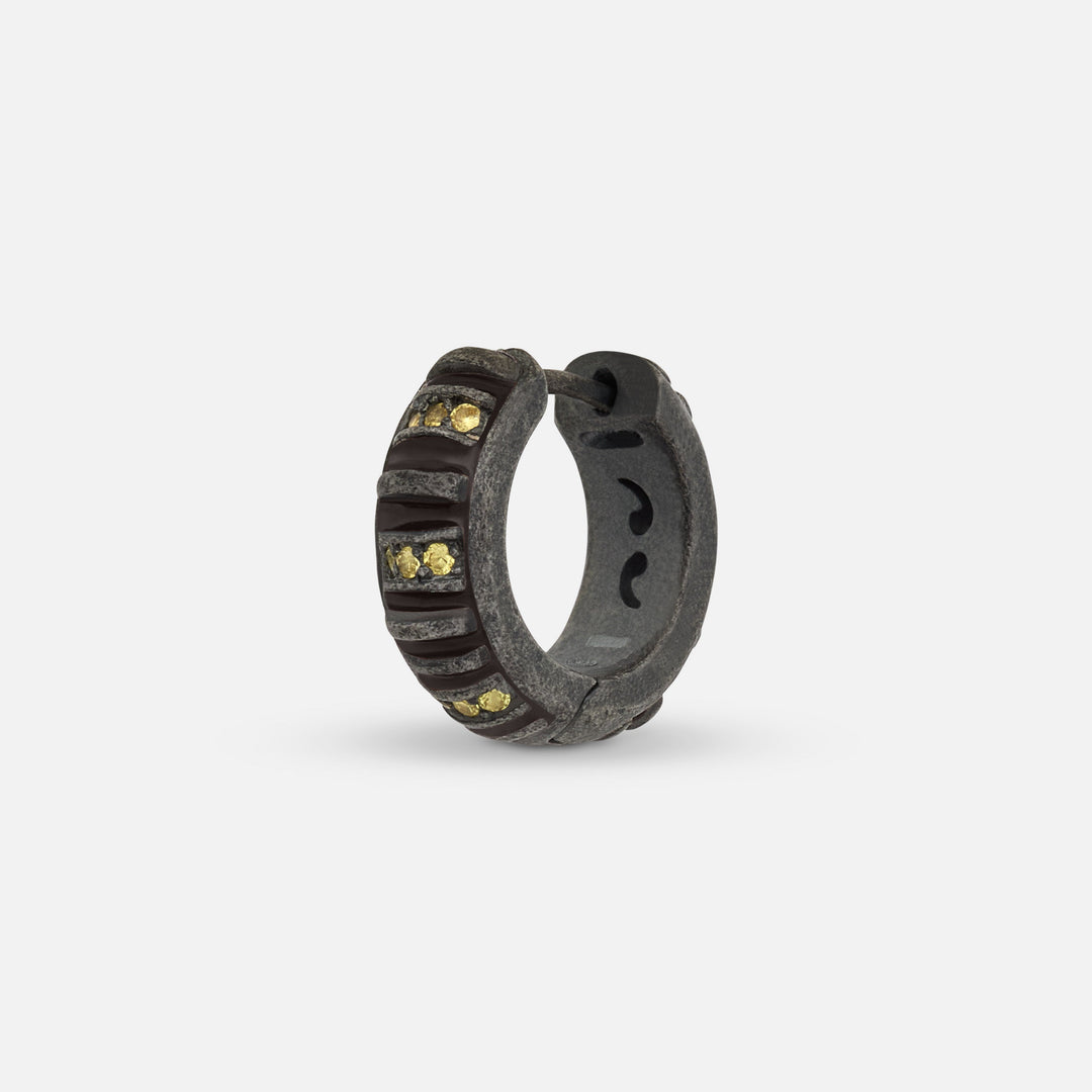 MARCO DAL MASO Acies Mini Pavé Hoop Earring in oxidized silver with brown enamel and yellow sapphires, shown in an angled product view highlighting the gemstone accents and textured finish.