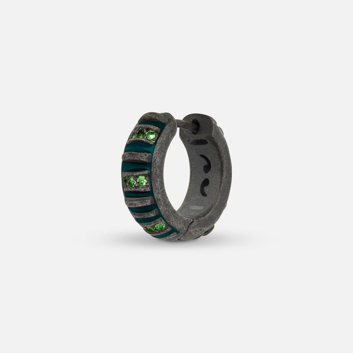 MARCO DAL MASO Acies Mini Pavé Hoop Earring in oxidized silver with green enamel and sparkling tsavorite gemstones, shown in an angled product view against a light background.