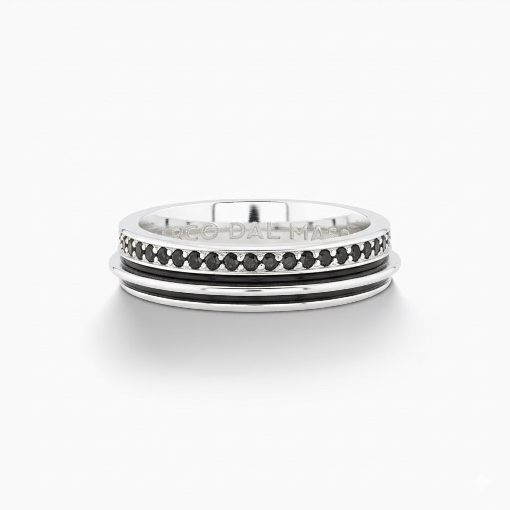 Frontal view of rotating ring presenting channel inlay on white table.