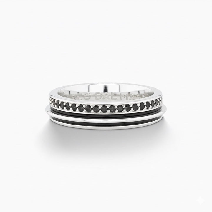 Frontal view of rotating ring presenting channel inlay on white table.
