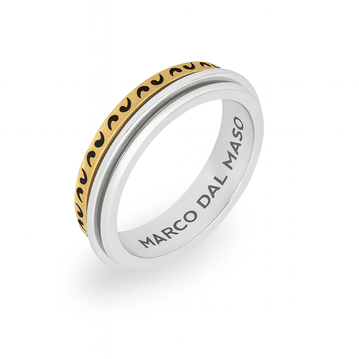 Engraved band in sterling silver and yellow gold on a plain setup.