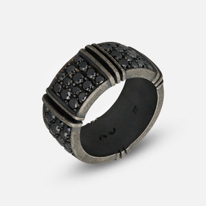 Wide band in rustic metal and dark crystals on an off-white plane.