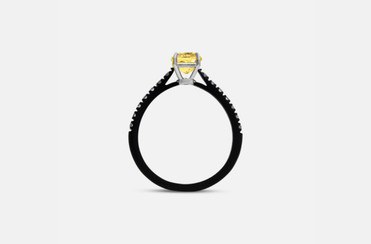 MARCO DAL MASO Eclipse Celeste Ring featuring a yellow diamond in a raised setting above a dark band, shown in a side-profile product view against a light background.