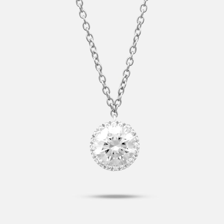MARCO DAL MASO Eclipse Luna Halo Pendant featuring a brilliant round white diamond surrounded by a halo of smaller sparkling stones, suspended from a delicate silver-tone chain against a light background.