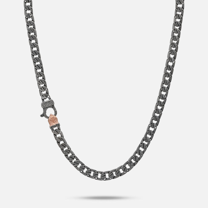 MARCO DAL MASO Flaming Tongue 6mm Necklace in oxidized silver and rose gold vermeil with black diamonds, featuring a Cuban link chain and decorative clasp, displayed against a light background.
