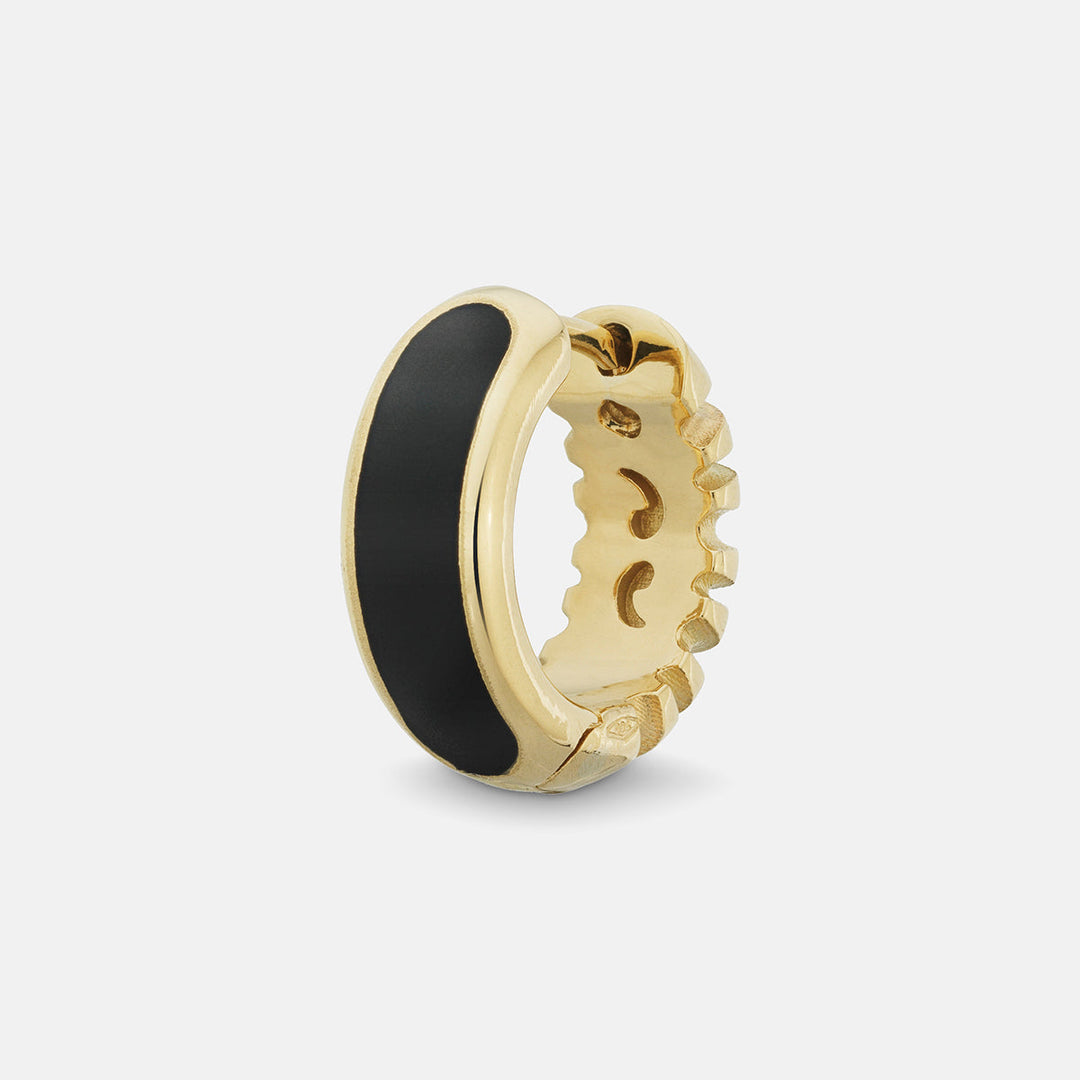 MARCO DAL MASO Frame Enamel Hoop Earring in 18k yellow gold with black enamel detailing, featuring a wide curved design and polished gold edges, shown in an angled product view against a light background.