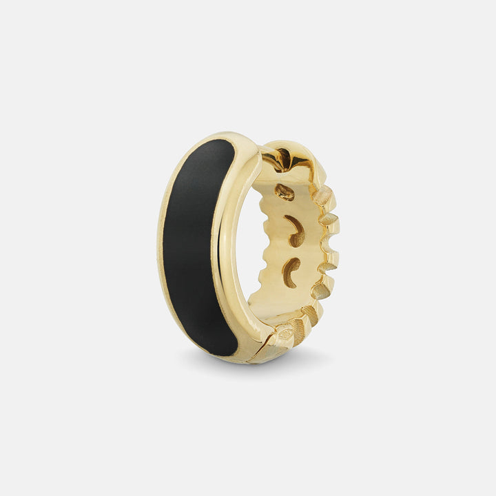 MARCO DAL MASO Frame Enamel Hoop Earring in 18k yellow gold with black enamel detailing, featuring a wide curved design and polished gold edges, shown in an angled product view against a light background.