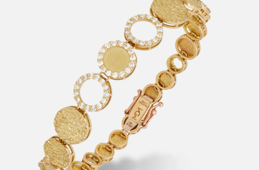 MARCO DAL MASO Frammenti Cascade Bracelet in 18k yellow gold, featuring textured circular links and sparkling gemstone-set accents, shown in a close-up product view.