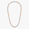 Chain strand in amber stones and steel links on minimal background.
