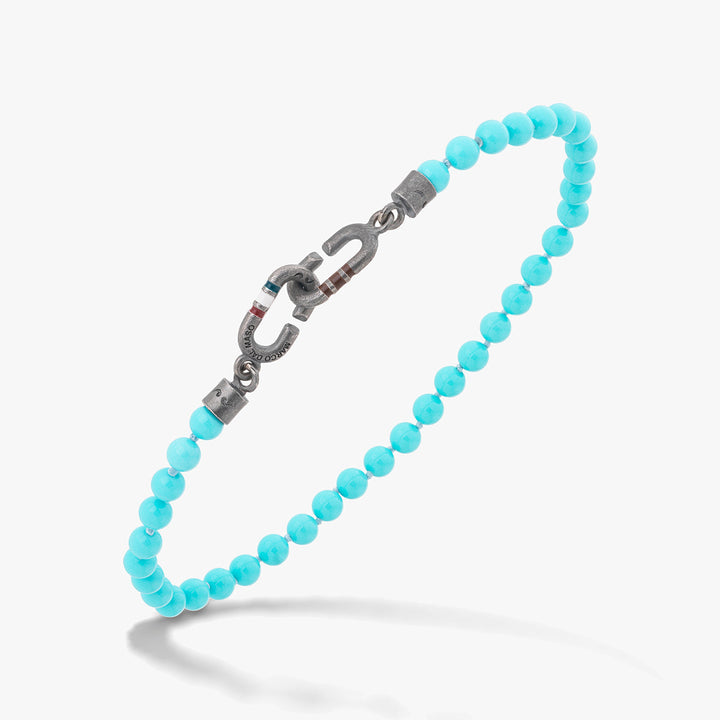 Turquoise chain in bright beads and metal on a clean background.