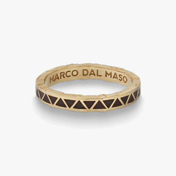 Angled view of engraved ring exposing interior branding on white tray.