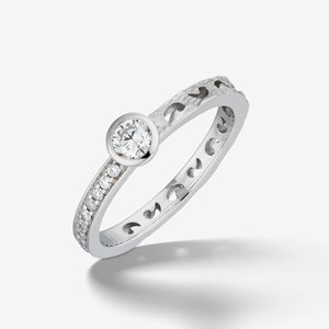 MARCO DAL MASO Orion Gemstone Ring in white gold with white diamonds, featuring a round central diamond, smaller diamond accents, and a textured band, shown in an angled product view.