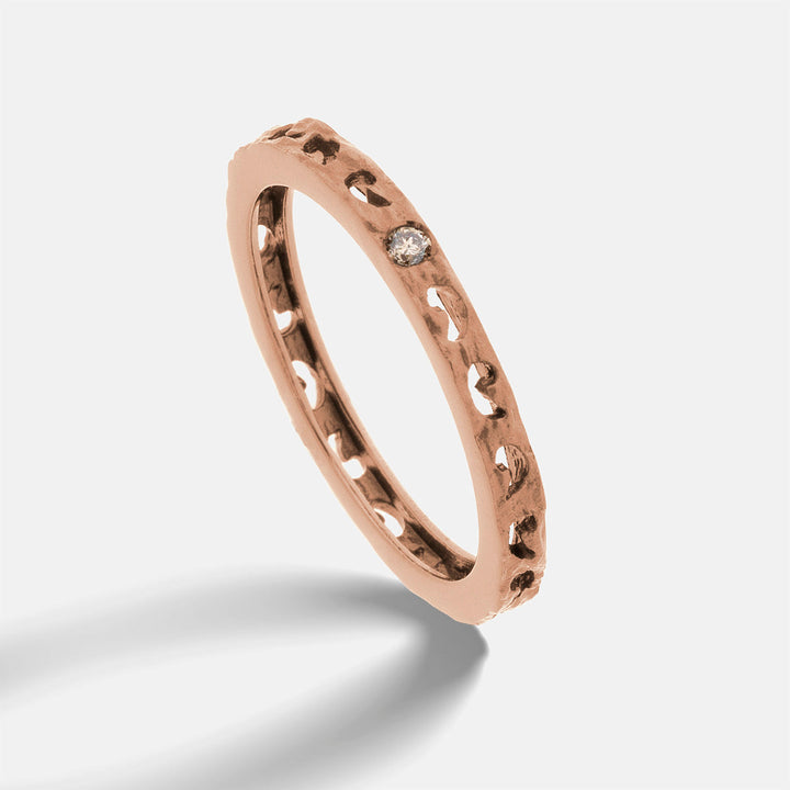 MARCO DAL MASO Orion Single Gemstone Ring in rose gold with a champagne diamond, shown in an angled product view with a textured band.