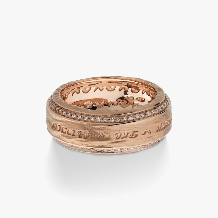 The Other Half Collection ring in textured rose gold and pavé diamonds presented on a minimalist bright surface.