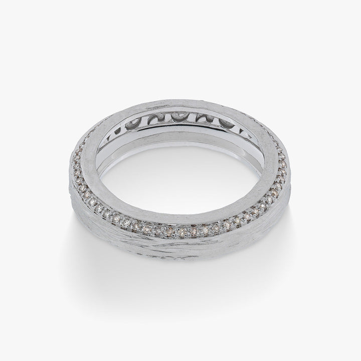 Front view of a silver-tone textured ring with a row of clear stones.