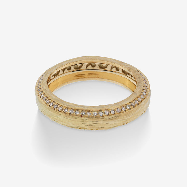 Gold-tone ring with engraved lettering and a row of clear stones.