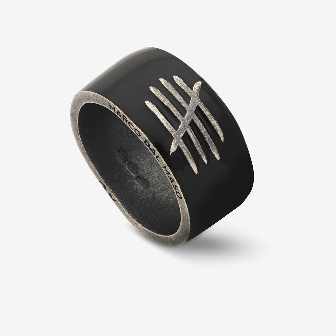 Oblique perspective of heavy ring exhibiting obsidian polish and crest.