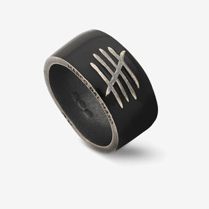 Oblique perspective of heavy ring exhibiting obsidian polish and crest.