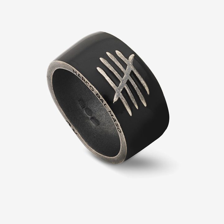 Oblique perspective of heavy ring exhibiting obsidian polish and crest.
