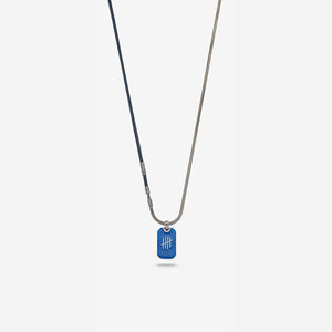 Vertical shot of mixed strand featuring sapphire pendant on light stage.