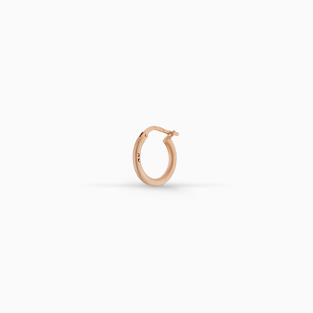 MARCO DAL MASO Ulysses Slick Hoop Earring in matte rose gold vermeil, featuring a minimalist circular design and hinged closure, displayed against a clean white background.