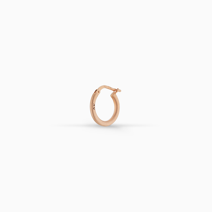 MARCO DAL MASO Ulysses Slick Hoop Earring in matte rose gold vermeil, featuring a minimalist circular design and hinged closure, displayed against a clean white background.