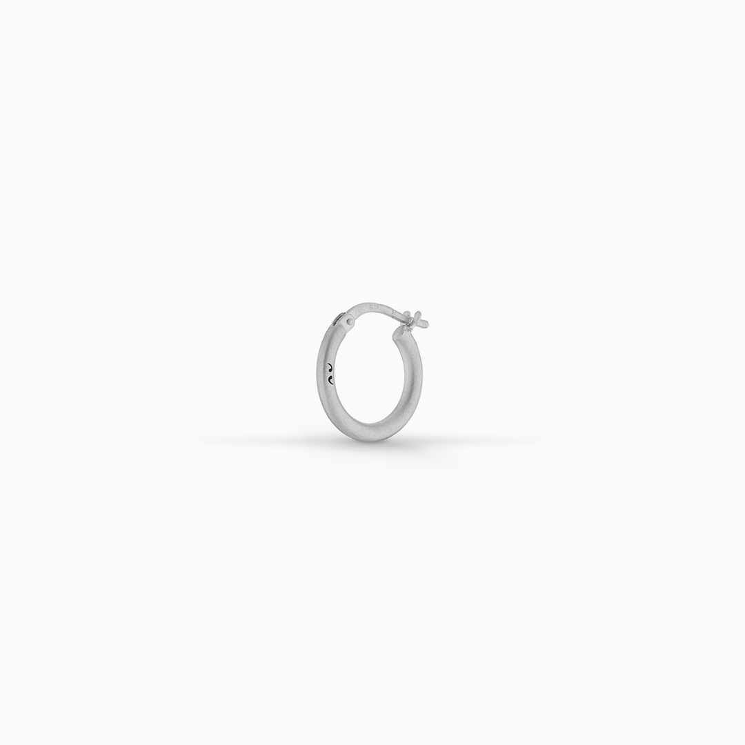 MARCO DAL MASO Ulysses Slick Hoop Earring in polished silver, featuring a sleek circular design and hinged closure, displayed against a clean white background.