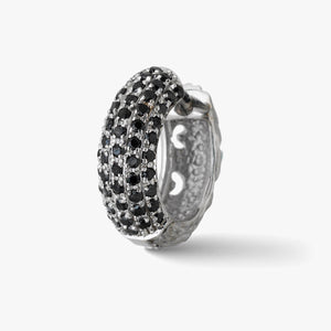 Pave earring in sterling silver and black stones on a pale background.