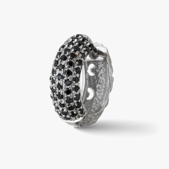 Pave earring in sterling silver and black stones on a pale background.