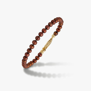 Bracelet with brown beads and a gold-tone clasp.