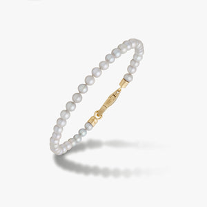 White pearl bracelet with a gold-tone clasp.