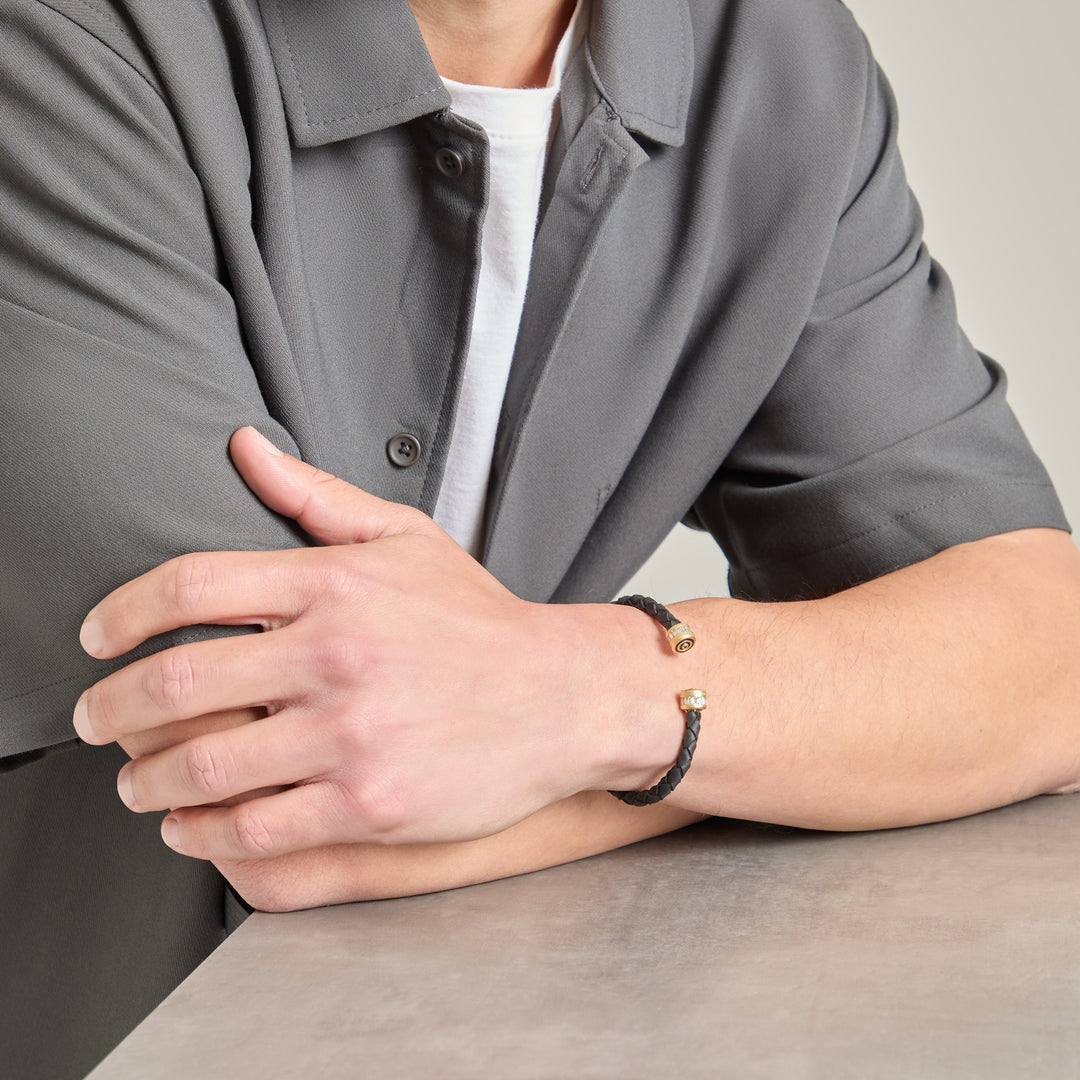 Arm angle view of braided cuff paired with a grey shirt and tee.