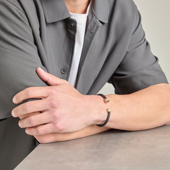 Arm angle view of braided cuff paired with a grey shirt and tee.