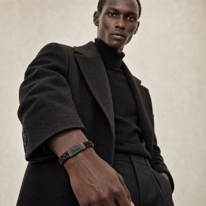 Model wearing the MARCO DAL MASO Gladiator Bracelet in oxidized silver, black diamonds and black braided leather, featuring a rectangular decorative centerpiece in a contemporary fashion portrait.