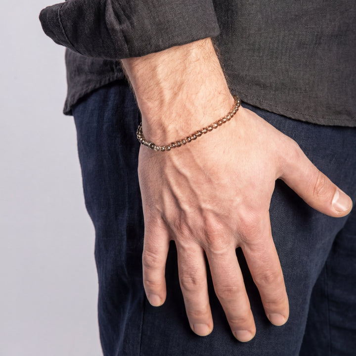 Model wearing the LINK Mini Beads Eternity Bracelet featuring smoky quartz beads.